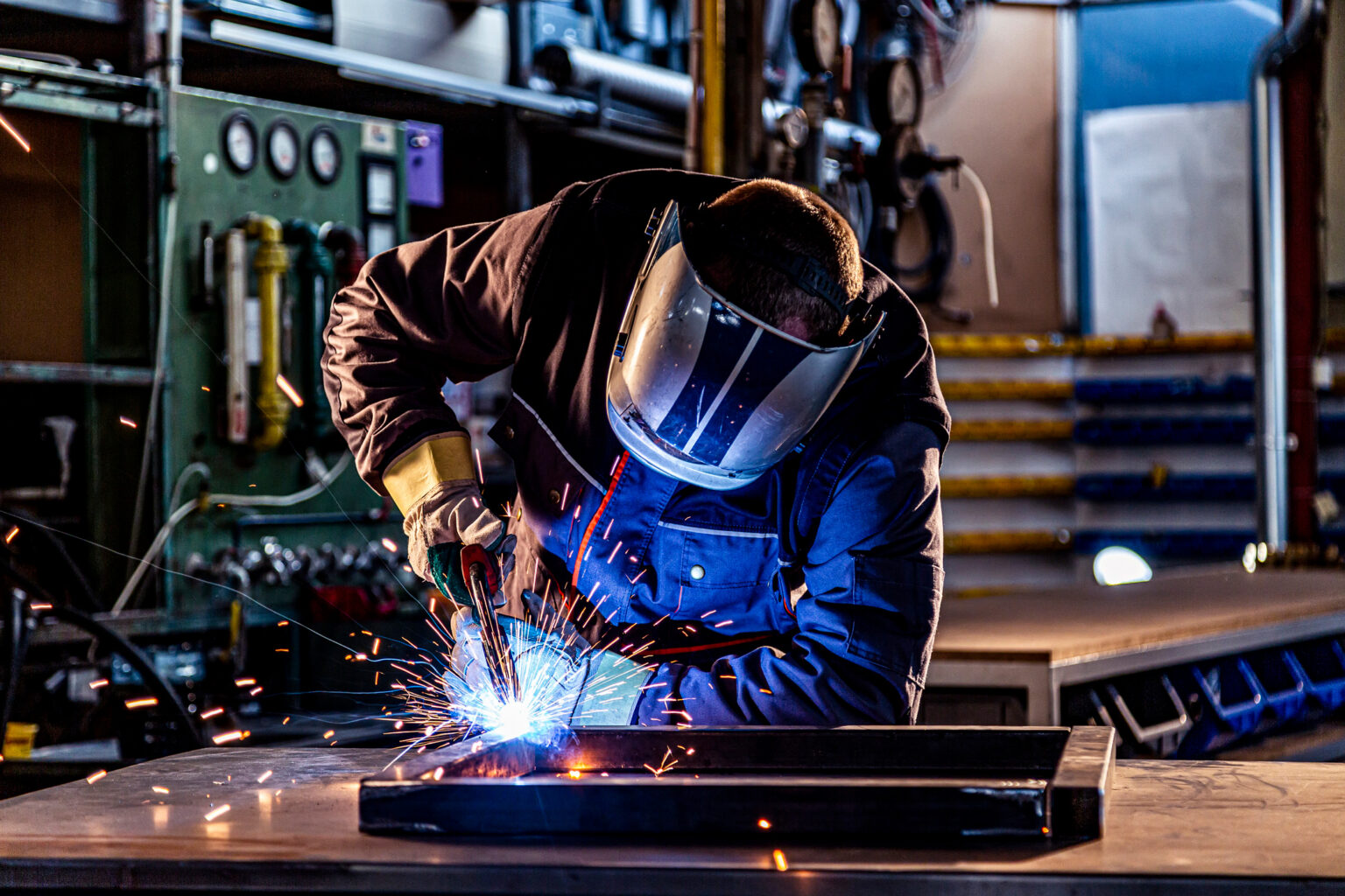 Welder working in a manufacturing facility